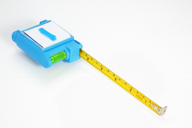 homeowner planning kitchen renovation with notebook and measuring tape on a table